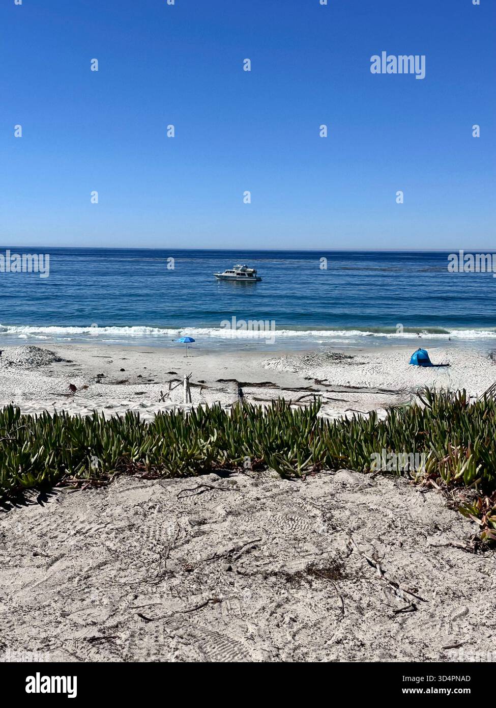 Boat offshore with waves and sandy beach, Monterey Bay California - Smartphone Captured Stock Image