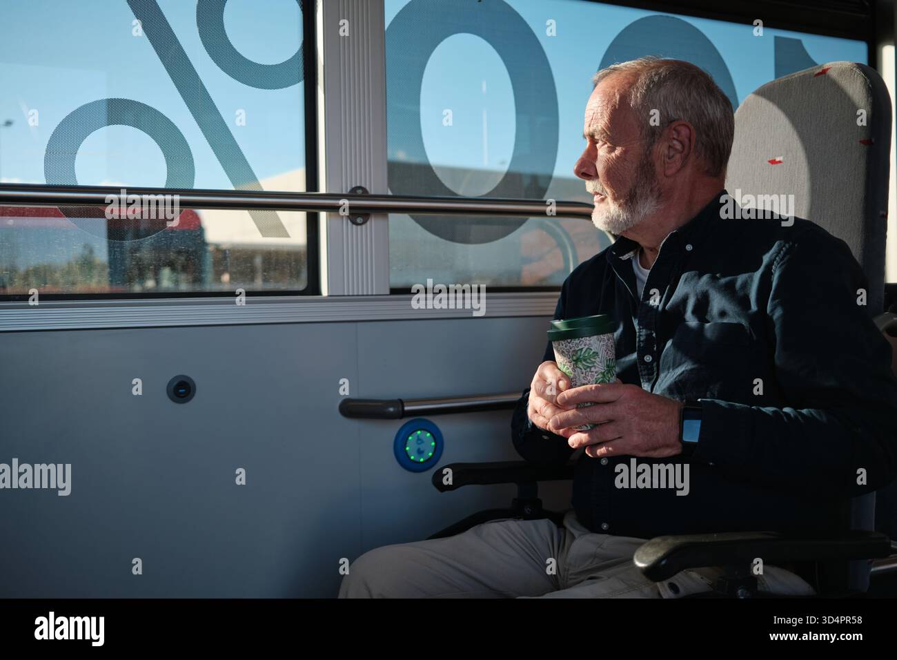 Senior man commuting on bus, looking out window Stock Photo