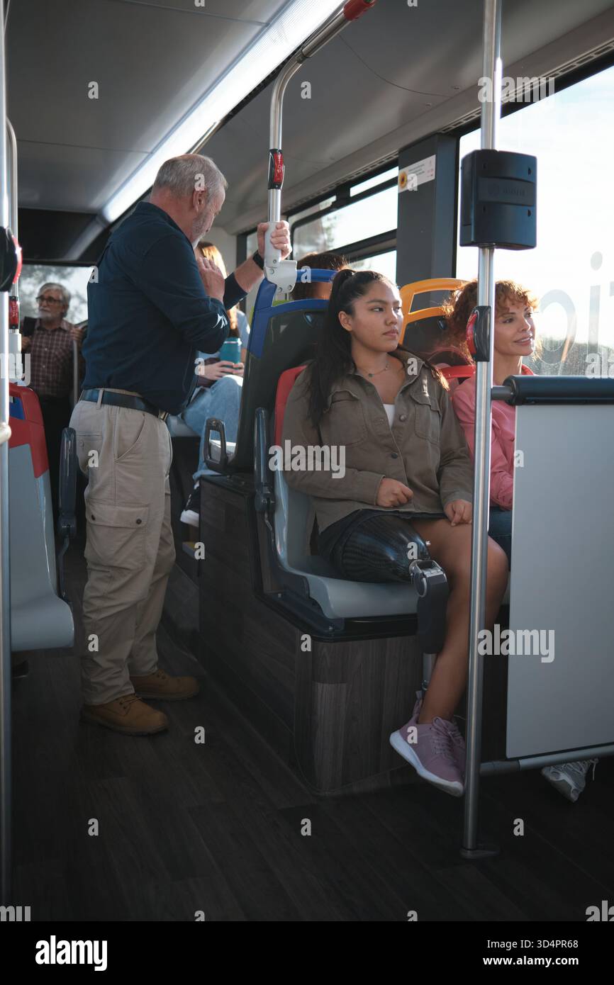 Woman with prosthetic leg commuting on bus Stock Photo
