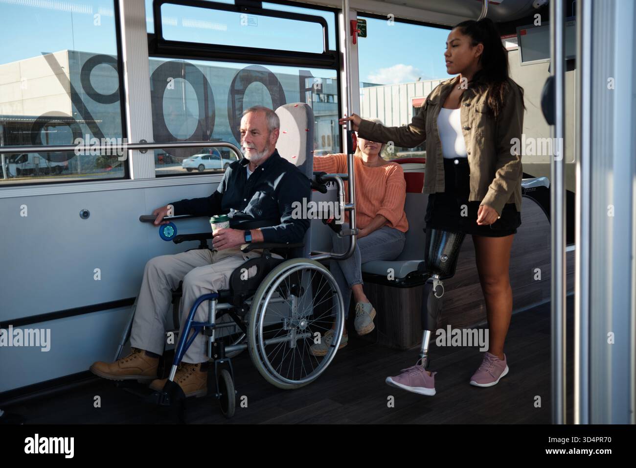 Diverse group of people using accessible public bus Stock Photo