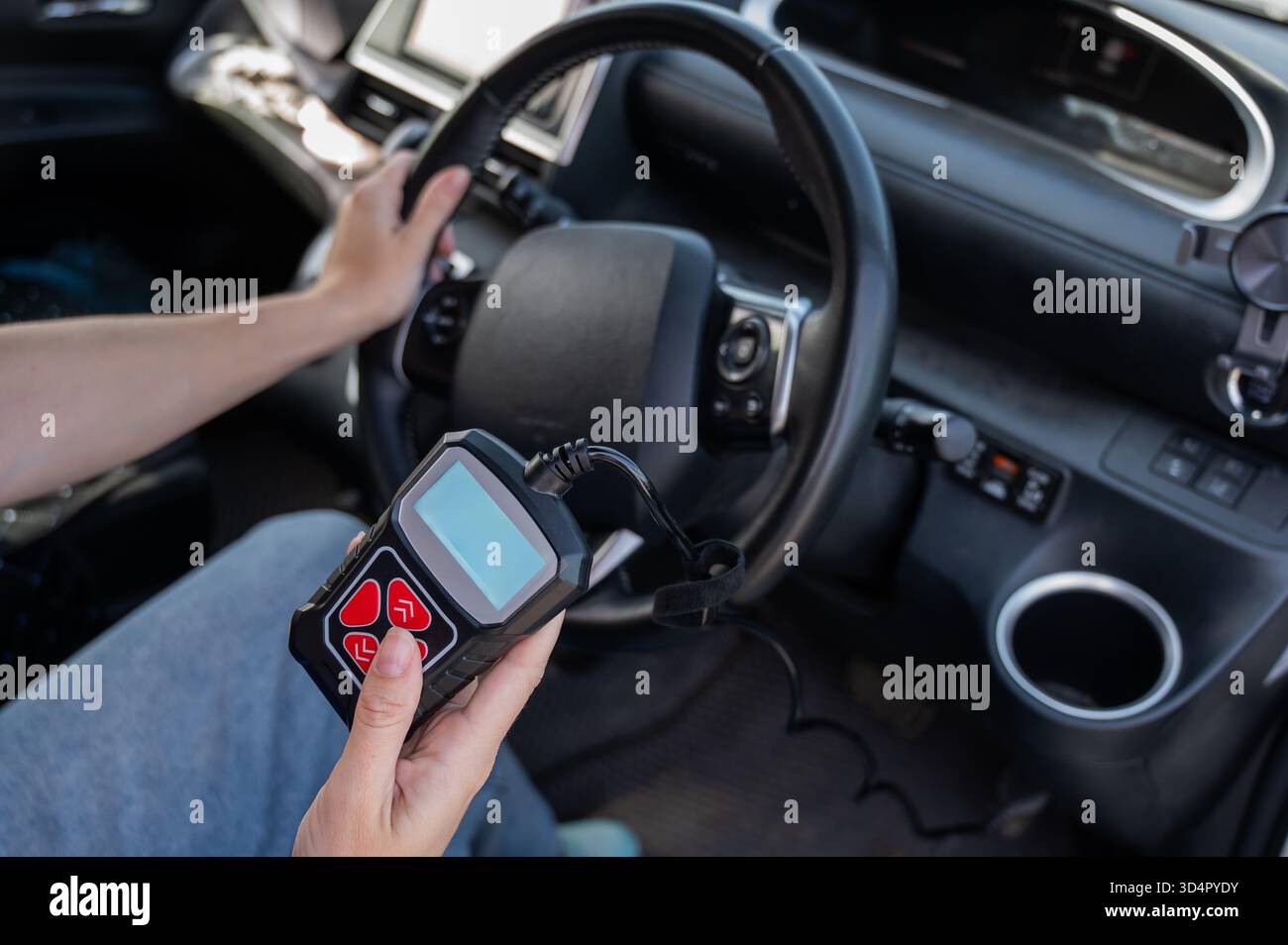 Woman using OBD2 diagnostic scanner.  Stock Photo