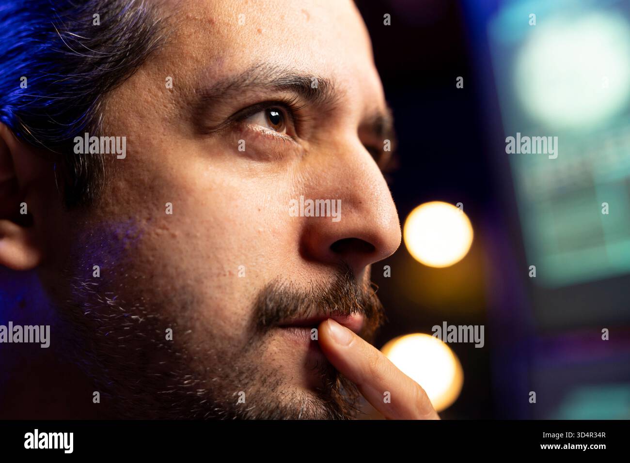 Close up of hacker focused on getting undetectable virus past antivirus protection. Cybercriminal in secret hideout concentrating on developing data mining script to breach firewalls Stock Photo