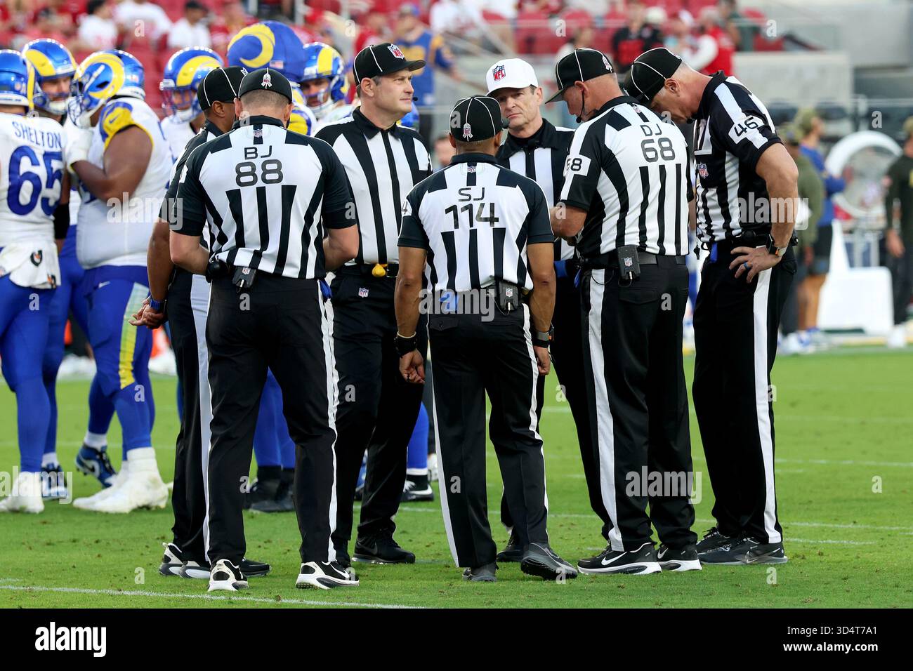 Referee Land Clark (130) and the officiating crew huddle in the fourth ...
