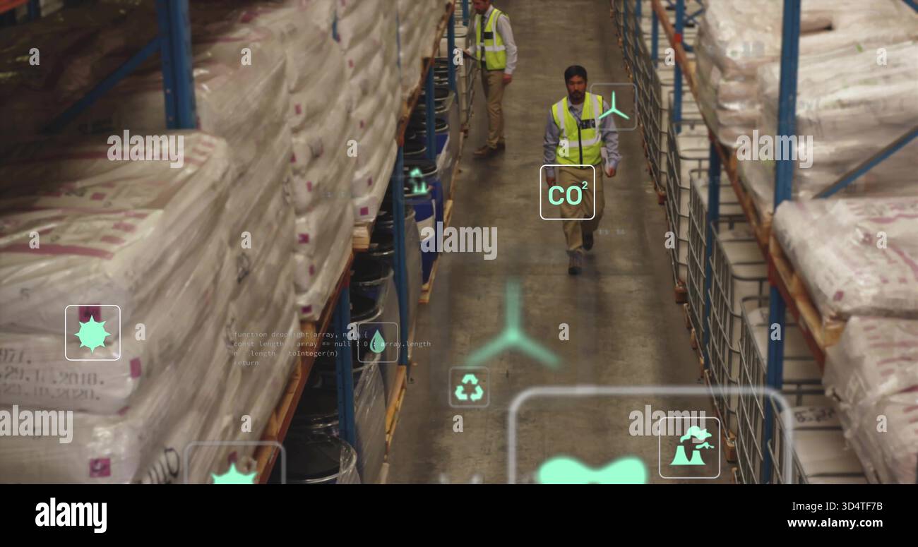 Walking warehouse workers in safety vests checking warehouse aisle, with sacks, drums and AR icons Stock Photo