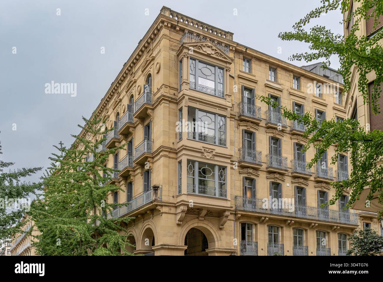 Elegant historic apartment building with beige stone facade, ornamental ...