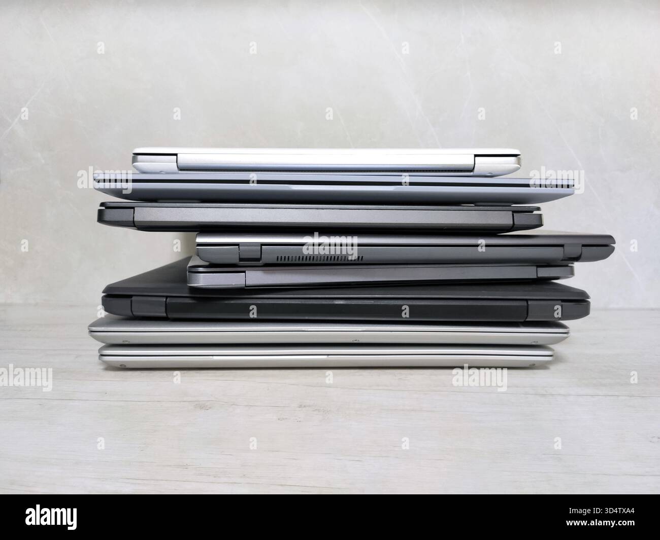 stack of laptops on a gray background, on the table, laptop computer, tablet, business, work, remote work, freelance. Stock Photo