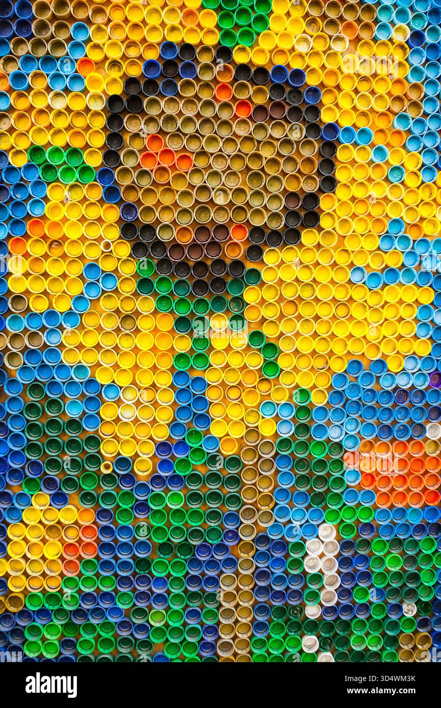 Plastic bottle caps are laid out in a pattern with flowers Stock Photo