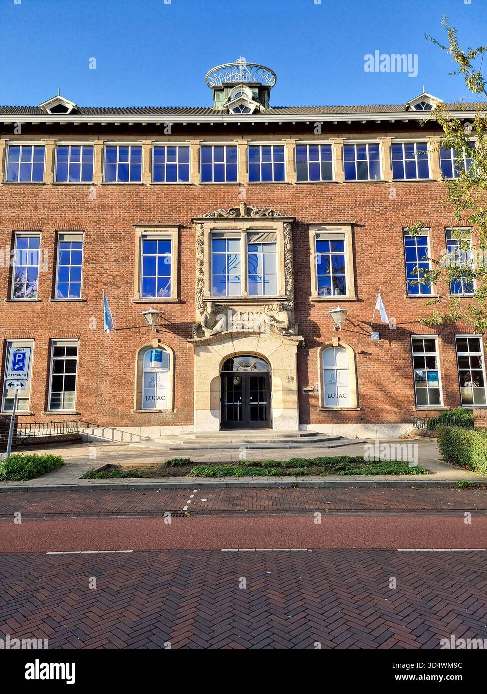 Monumental building facade of the former Middelbare Technische School (MTS), now Luzac College in Strijp, Eindhoven, The Netherlands - Smartphone Captured Stock Image