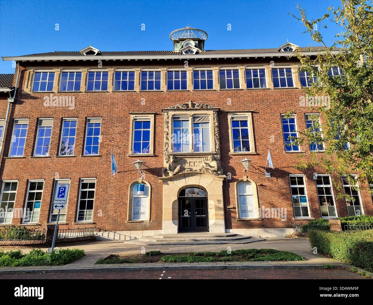 Monumental building facade of the former Middelbare Technische School (MTS), now Luzac College in Strijp, Eindhoven, The Netherlands - Smartphone Captured Stock Image