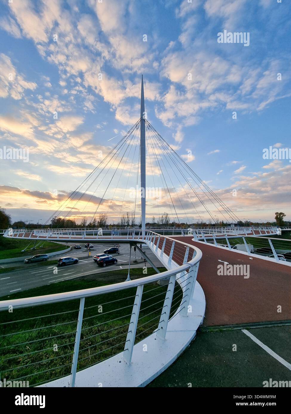 View on the Hovenring, an elevated roundabout for bicycles between Eindhoven & Veldhoven in the Netherlands against a beautiful sunny sky with clouds - Smartphone Captured Stock Image