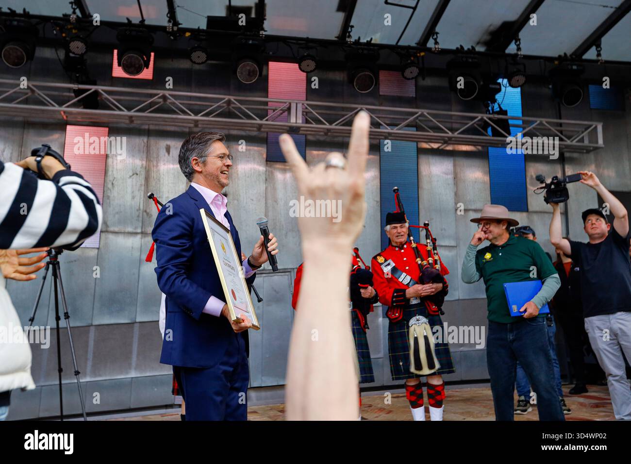 Lord Mayor of Melbourne Nicholas Reece speaks while holding an ...