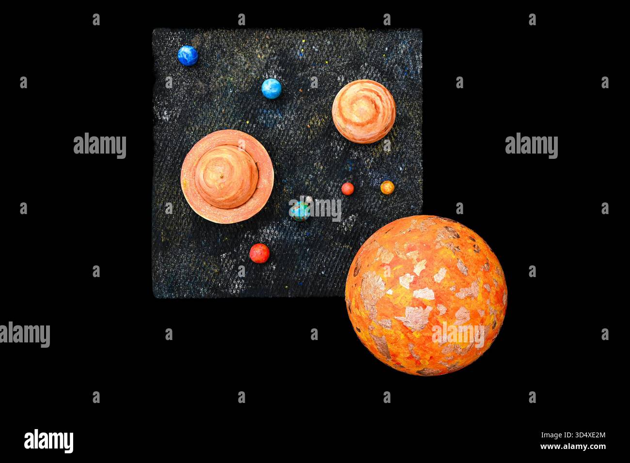 Craft model of the solar system with various planets orbiting a central ...