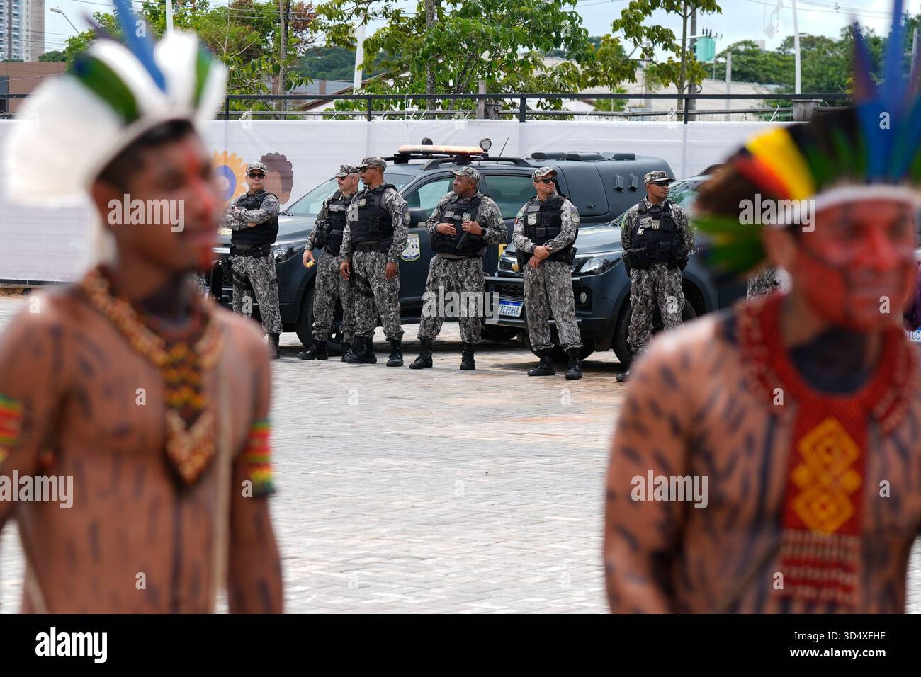 Security personnel monitor near Indigenous peoples outside the venue ...