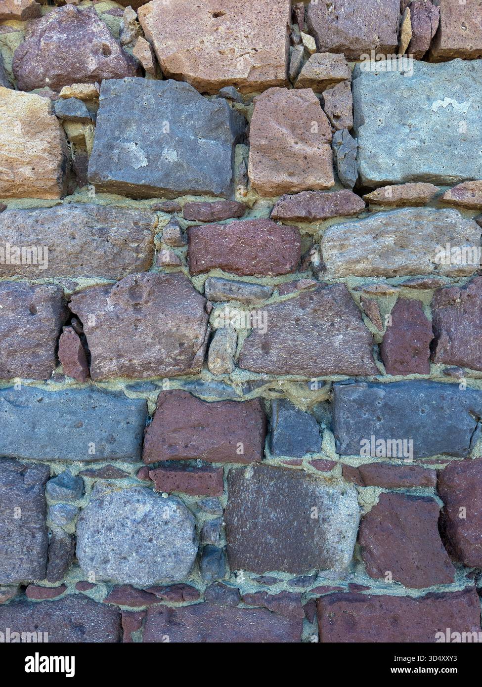 Rustic Stone Wall Texture with Mixed Volcanic Rocks Stock Photo