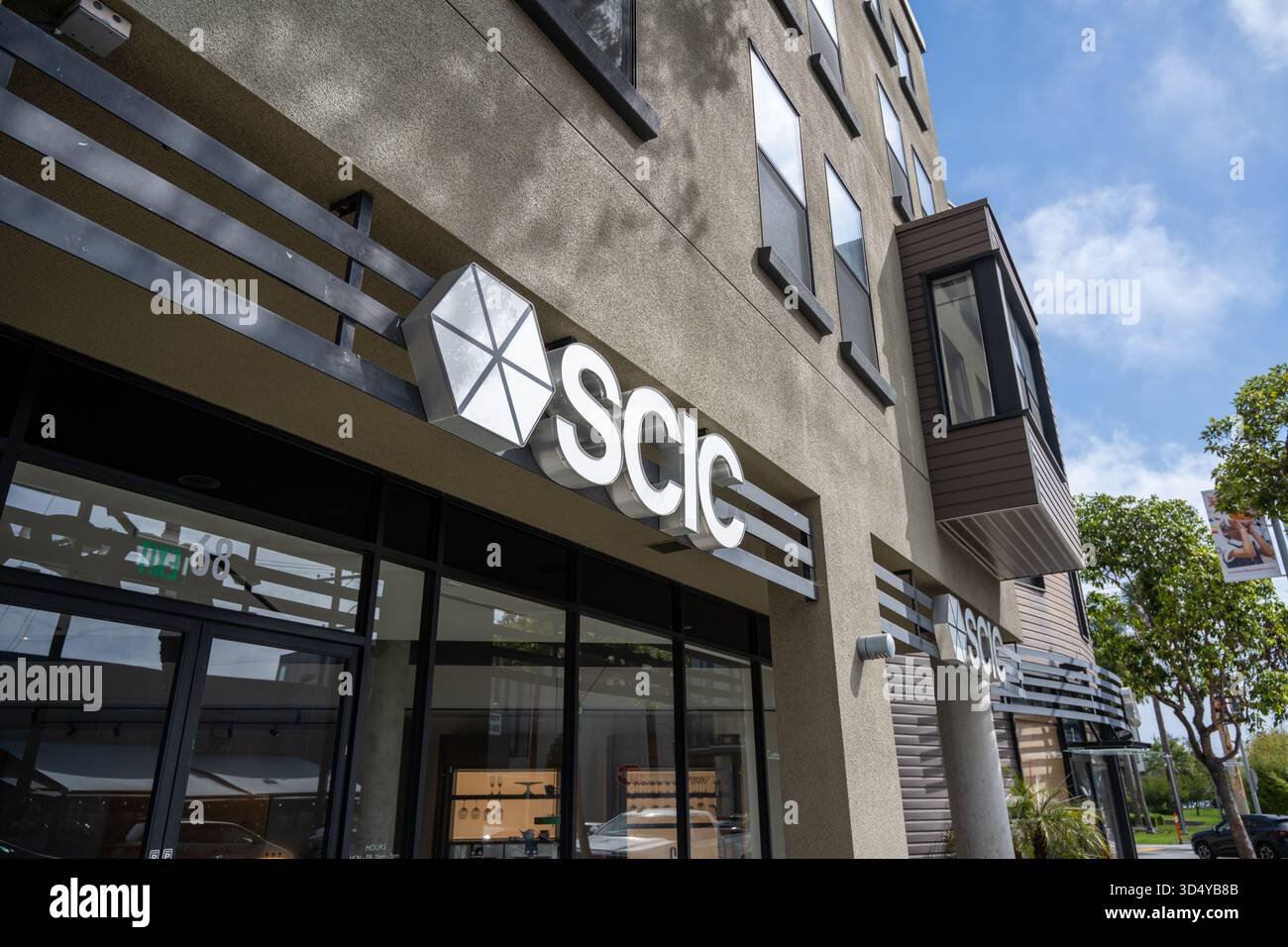 Scic Building SCIC storefront with geometric hexagon logo on modern mixed-use ...