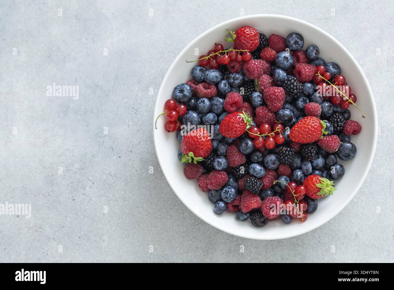 Food, Fresh summer organic berries in white bowl, healthy food concept, top view, copy space Stock Photo
