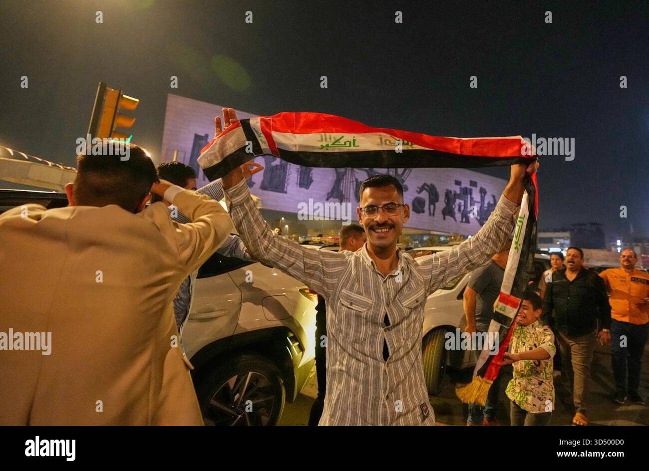 Supporters of Iraqi Prime Minister Mohammed Shia al-Sudani cheer in Tahrir Square, Baghdad, Iraq, Wednesday, Nov. 12, 2025, after results showed al-Sudani's bloc won the largest amount of seats in the parliamentary election. (AP Photo/Hadi Mizban) Stock Photo