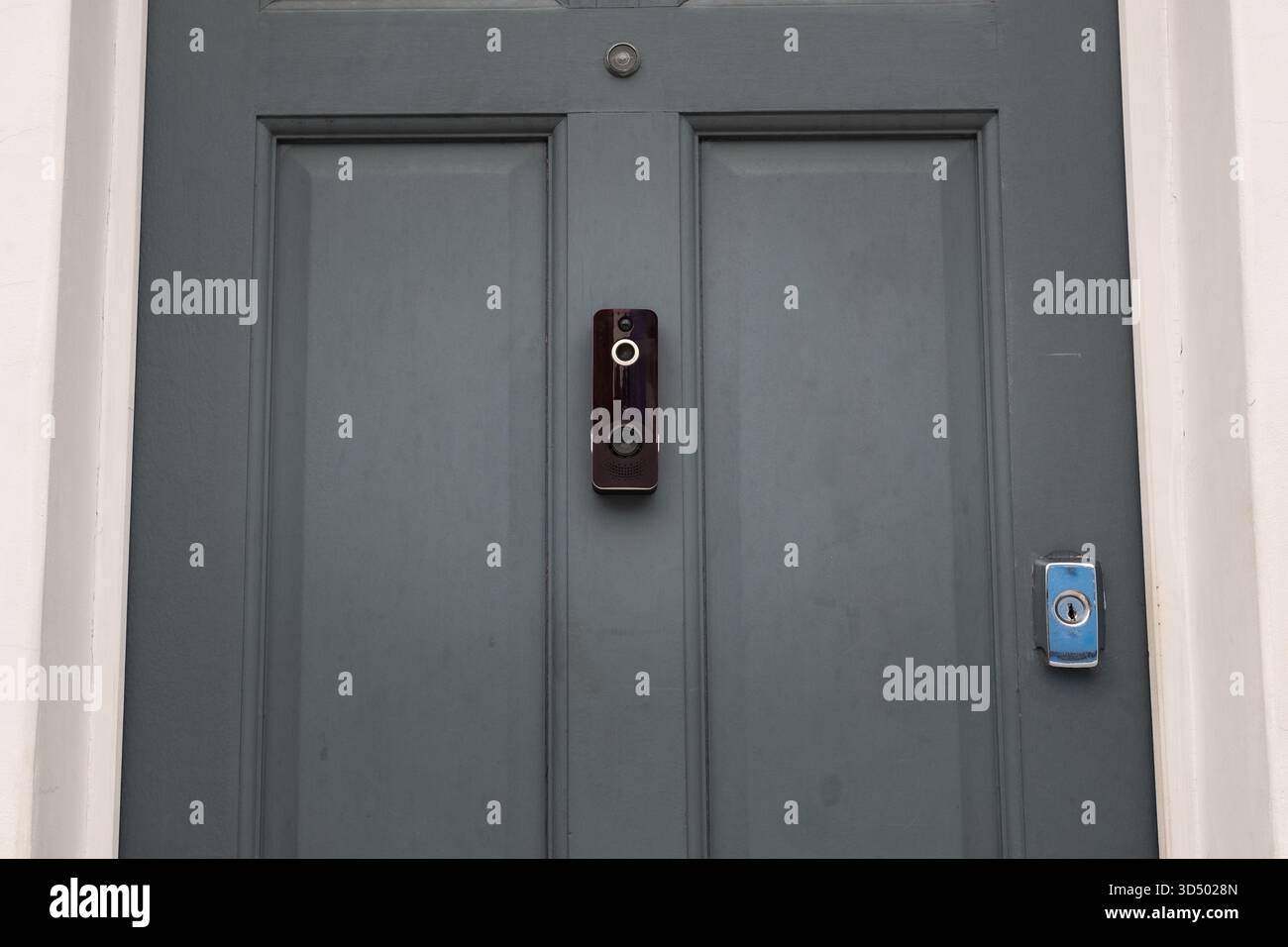 Grey front door with video doorbell camera. Residential house security Stock Photo