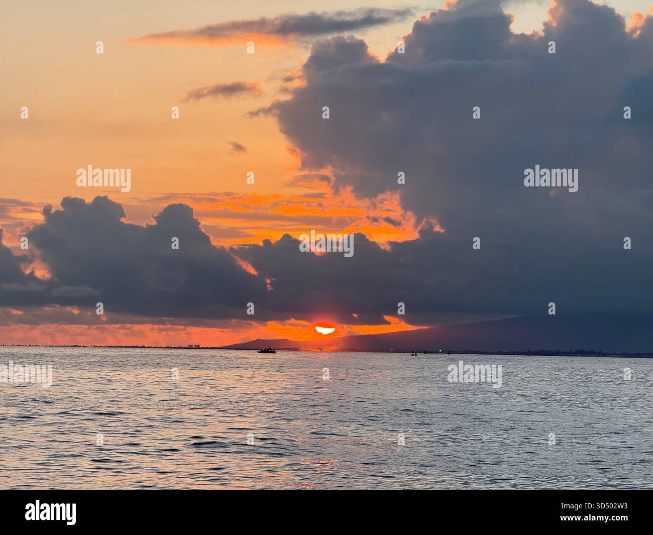 A firey pearl in the sky above the mountains and hills of Hawaii - Smartphone Captured Stock Image