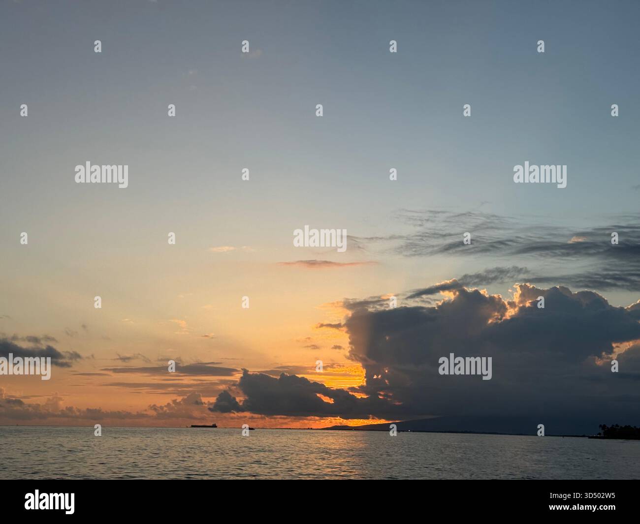 A Hawaiian sunset shrouded by the clouds of an oncoming storm - Smartphone Captured Stock Image