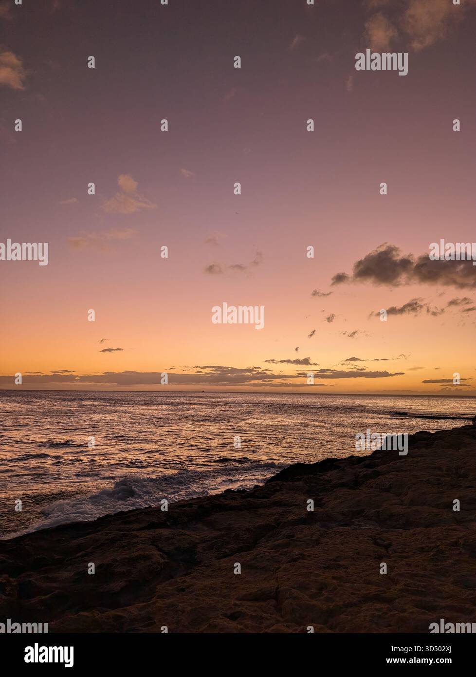 Purple sunset on a Hawaiian shore - Smartphone Captured Stock Image