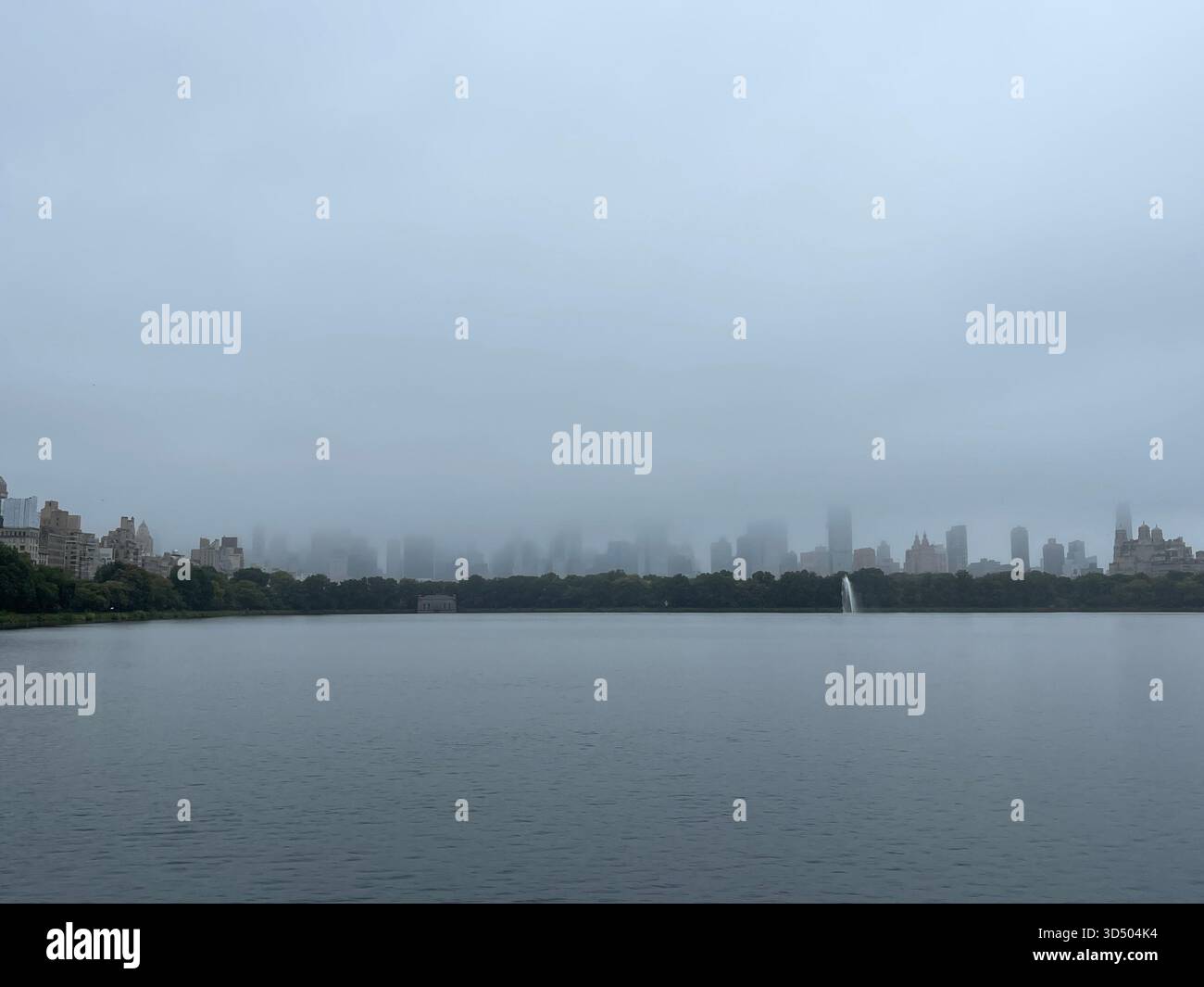 Tranquil reflections in the misty waters of Central Park’s Reservoir. - Smartphone Captured Stock Image