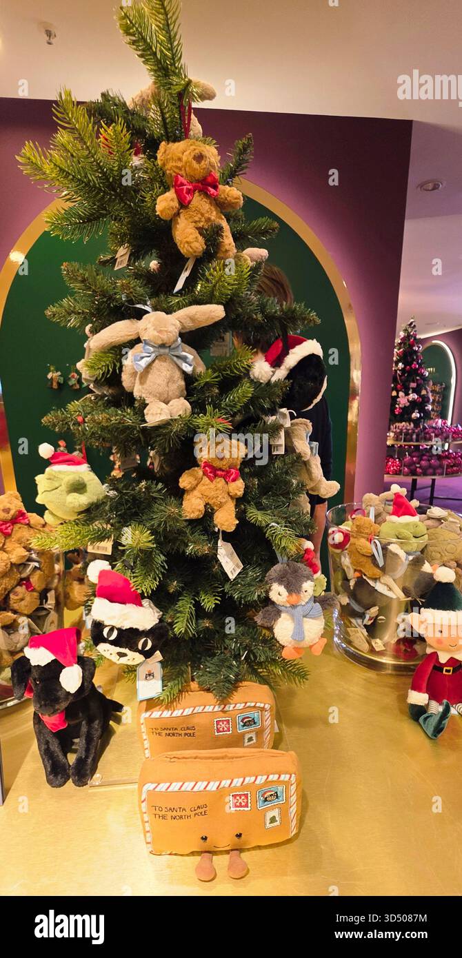 Berlin, Germany - September 19, 2025: Christmas tree adorned with plush toys and festive ornaments in store. - Smartphone Captured Stock Image