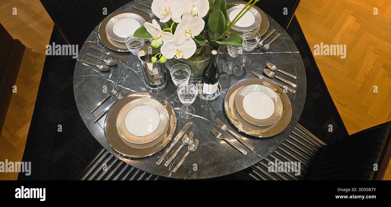 Berlin, Germany - September 19, 2025: Elegant dining table features flowers, fine china, and glassware for dinner. - Smartphone Captured Stock Image