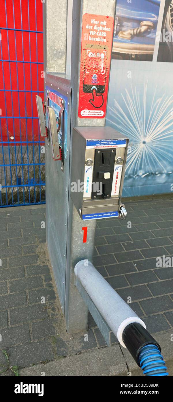 Berlin, Germany - September 27, 2025: Car wash payment station features vacuum cleaner and signage in urban setting. - Smartphone Captured Stock Image