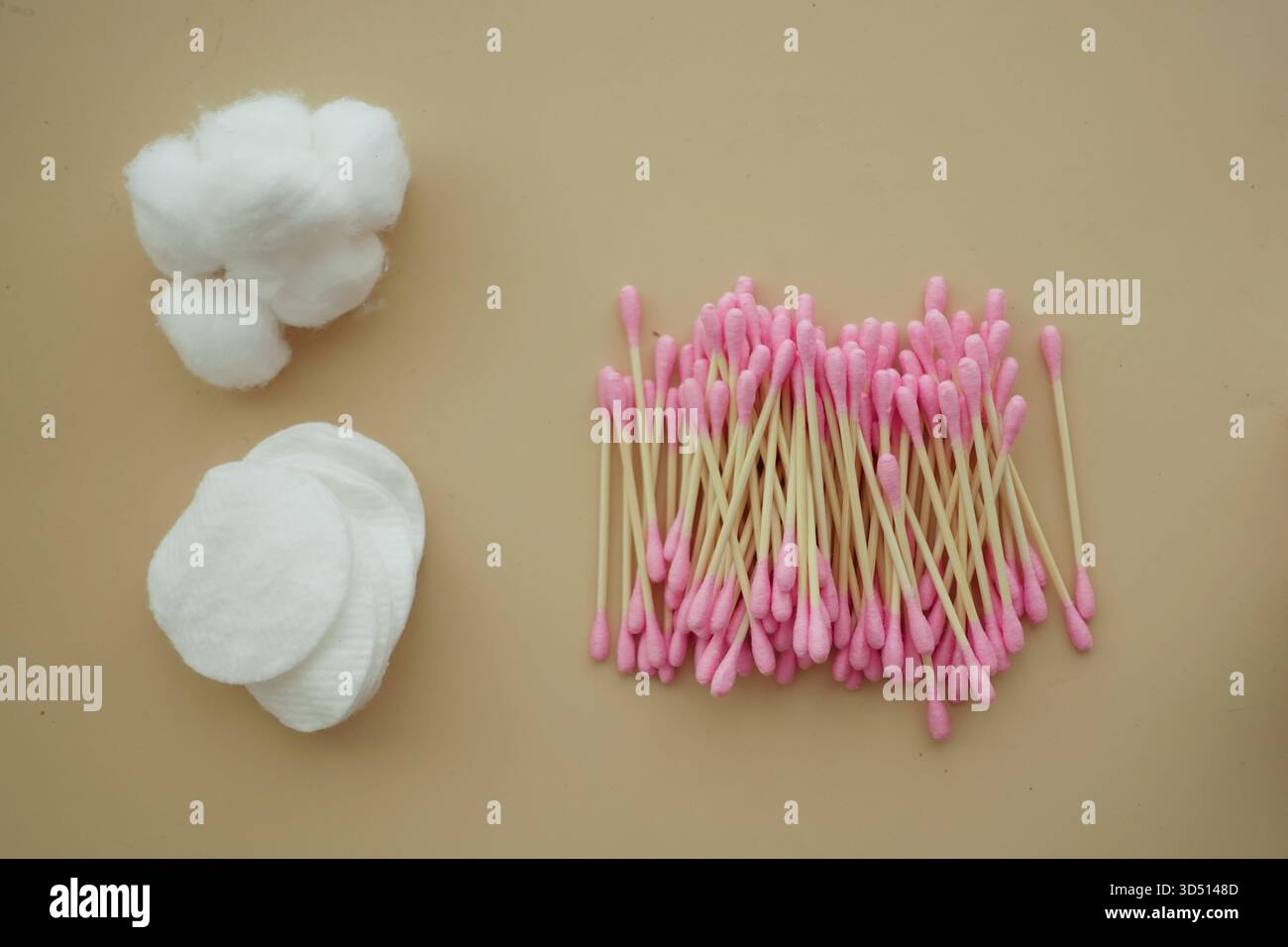 Cotton balls and swabs arranged on a plain surface Stock Photo