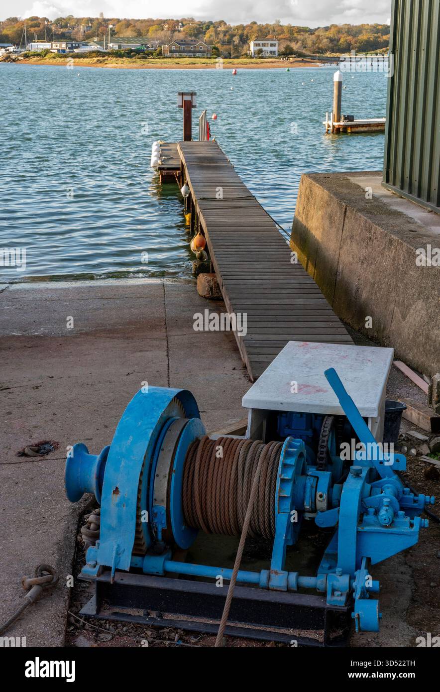 vintage wire cable boat winch on a slipway in Bembridge, Isle of wight for hauling vessels out of the water for maintenance in a boatyard. Old winch. Stock Photo