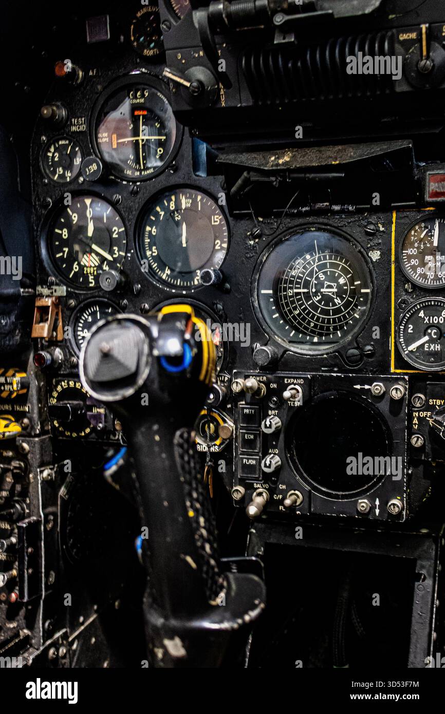Detailed view of aircraft cockpit instruments with illuminated control ...