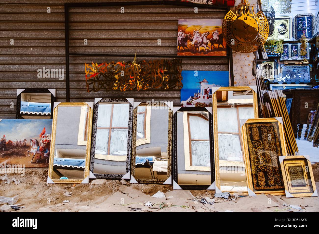 Rabat, Morocco – April 19, 2025: a traditional Moroccan market stall displays decorative mirrors, framed artwork, and Islamic calligraphy. The mirrors Stock Photo