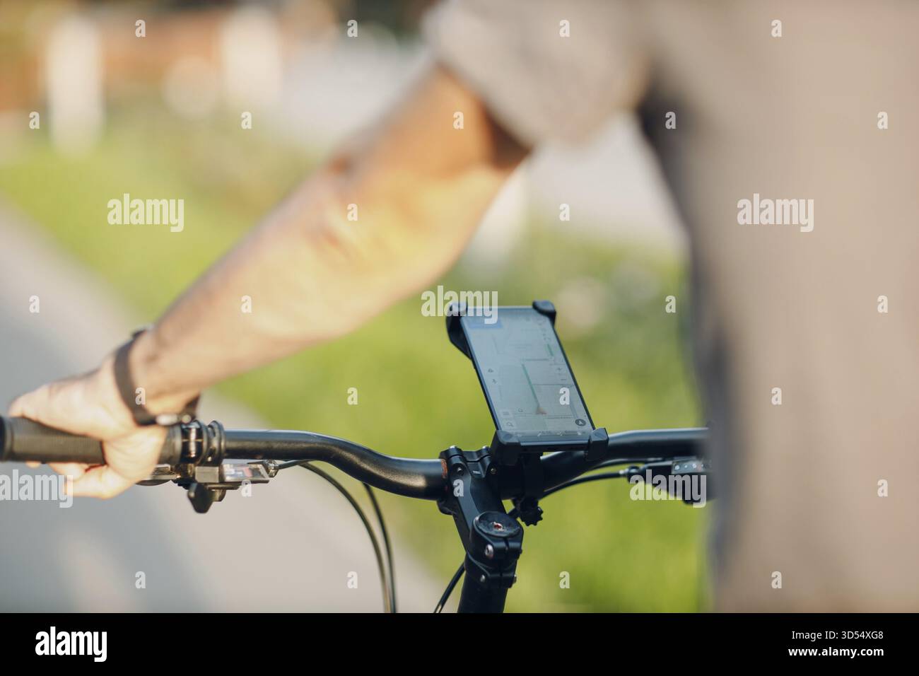 Man planning route using GPS navigation application in mobile phone on his bicycle bike Stock Photo