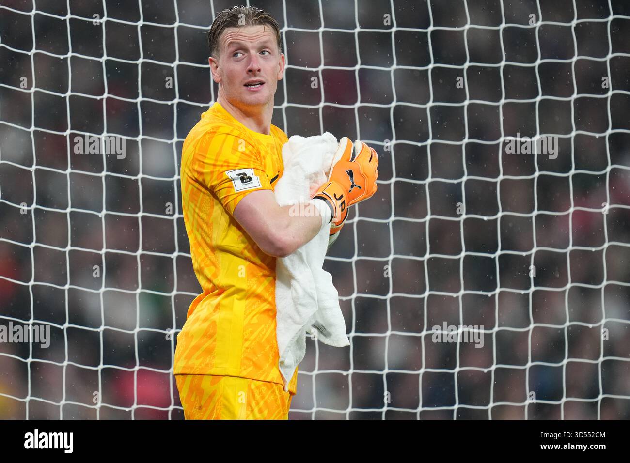 england-s-goalkeeper-jordan-pickford-wipes-off-his-gloves-during-a
