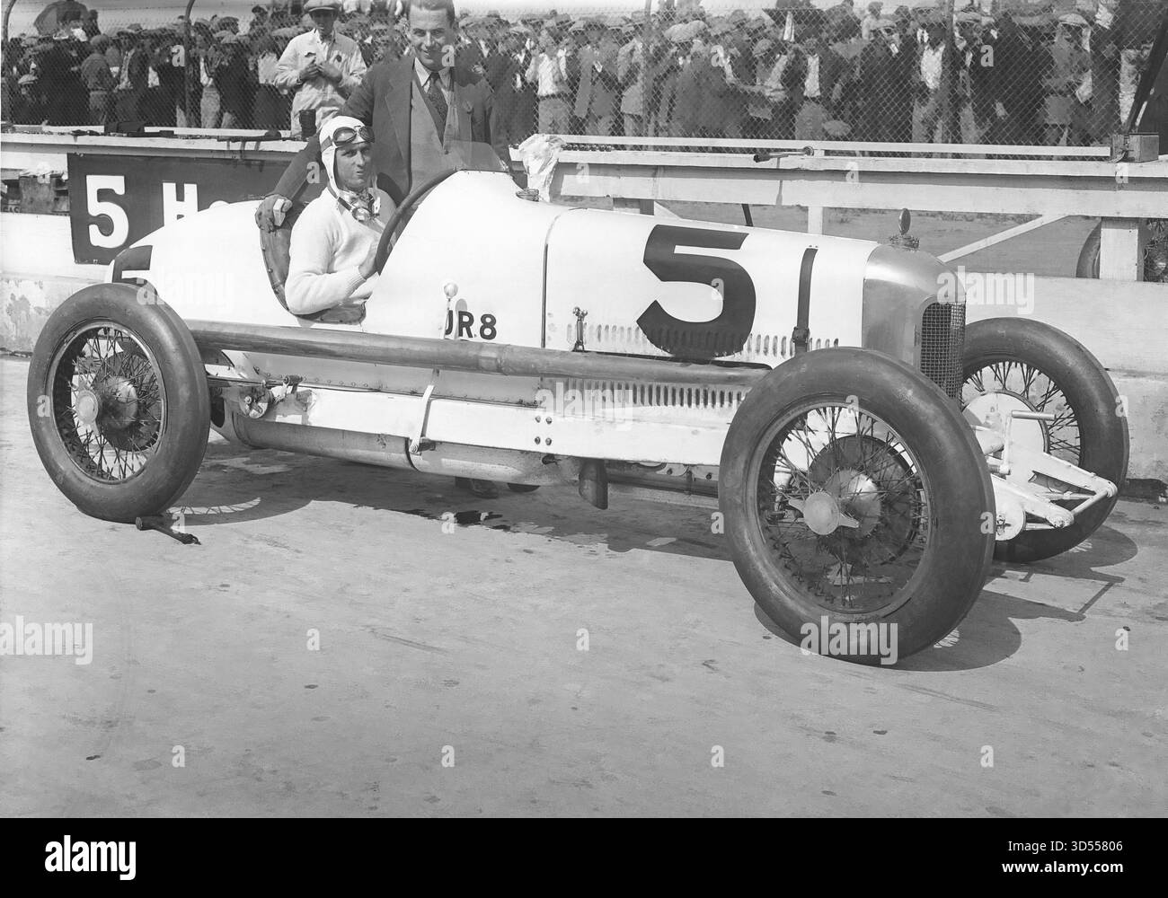 Early model racecar driver and owner Stock Photo - Alamy