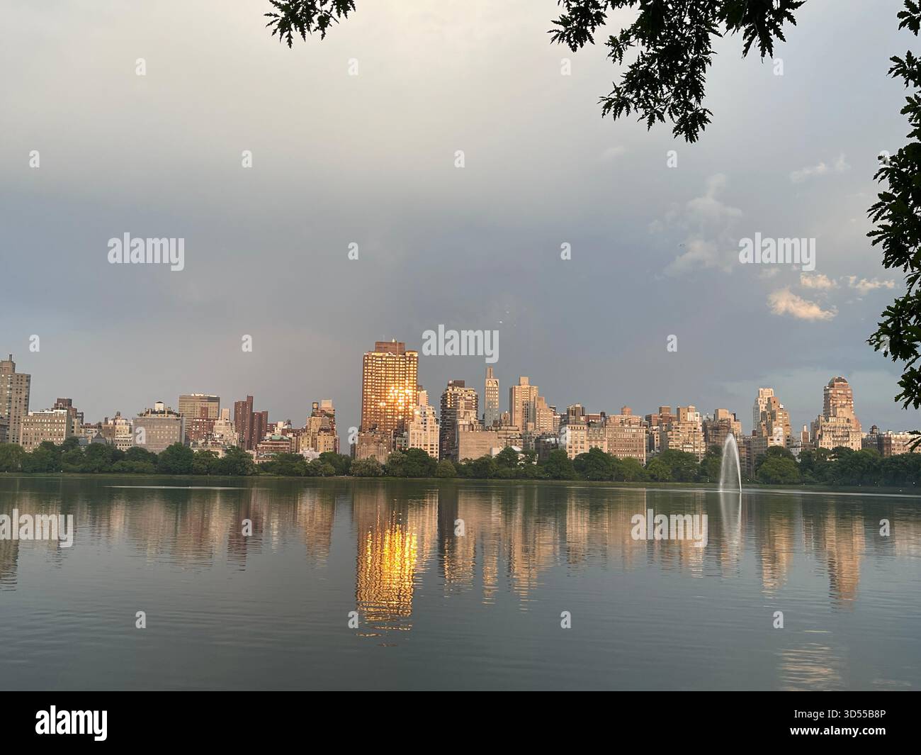 Central Park’s Reservoir bathed in warm sunlight on a serene day. - Smartphone Captured Stock Image