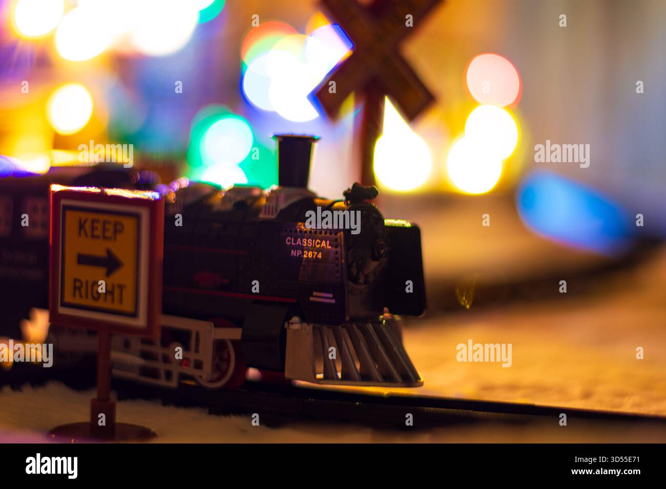 Close up of a miniature train arriving at snowy station at Christmas ...