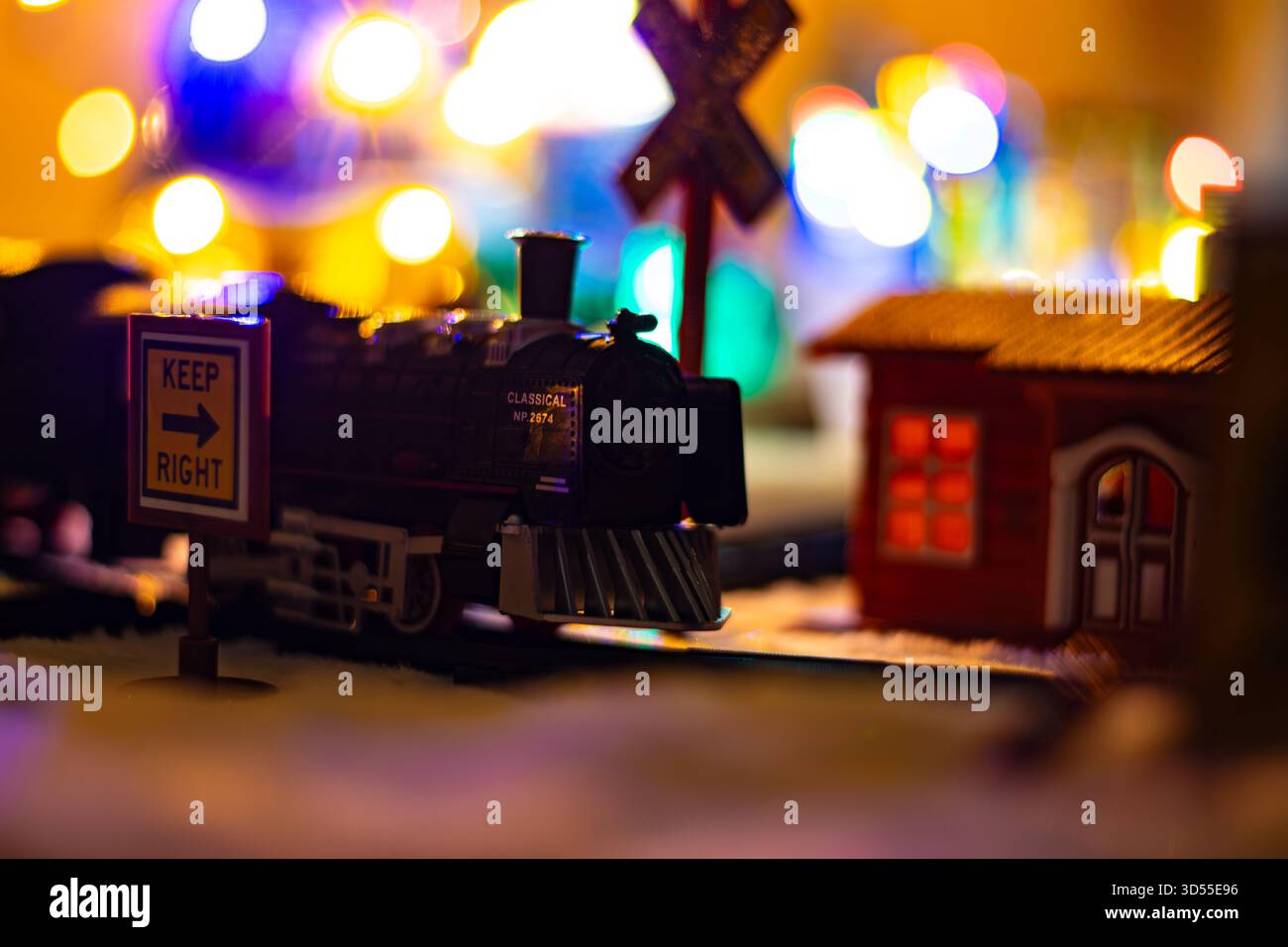 Close up of a miniature train arriving at snowy station at Christmas ...