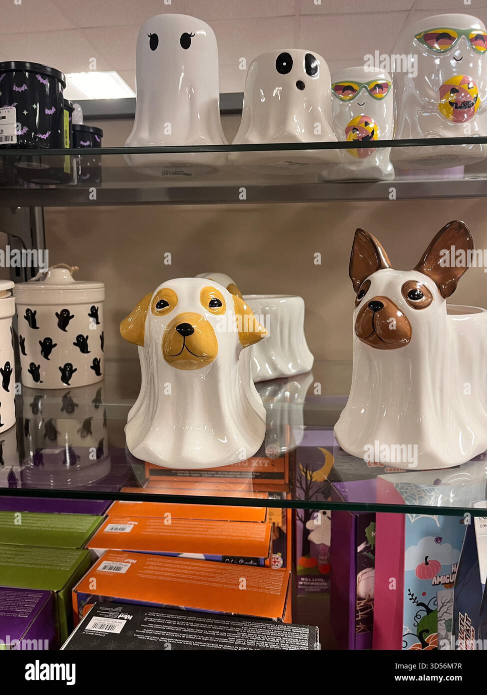 A playful display of dog-shaped and ghost-themed ceramic decorations inside a store in Hull, England. The colourful and whimsical ornaments create - Smartphone Captured Stock Image