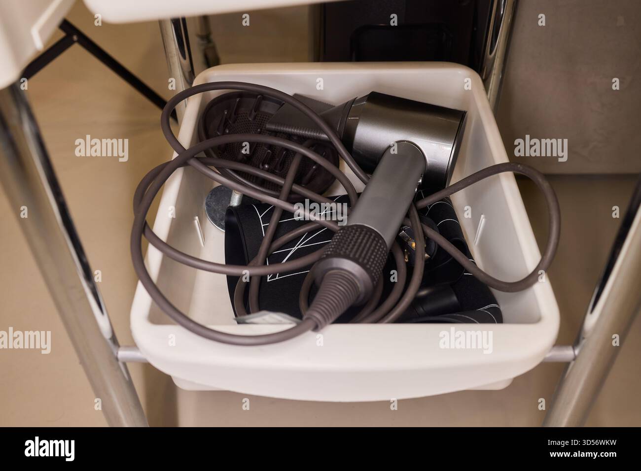 Chaotic styling station, Messy salon tools and cables, Disorganized ...