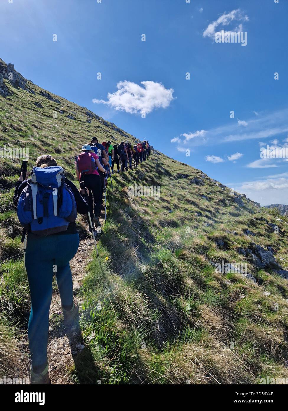 Hikers trekking across blue hi-res stock photography and images - Alamy