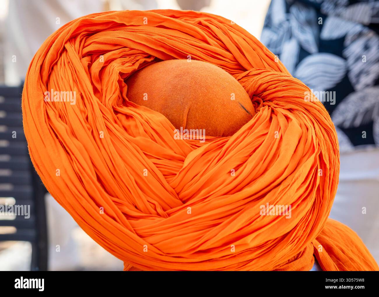 Berber dressed a traditional turban, Ouarzazate, Morocco. Moroccan man with orange turban, top view. Stock Photo