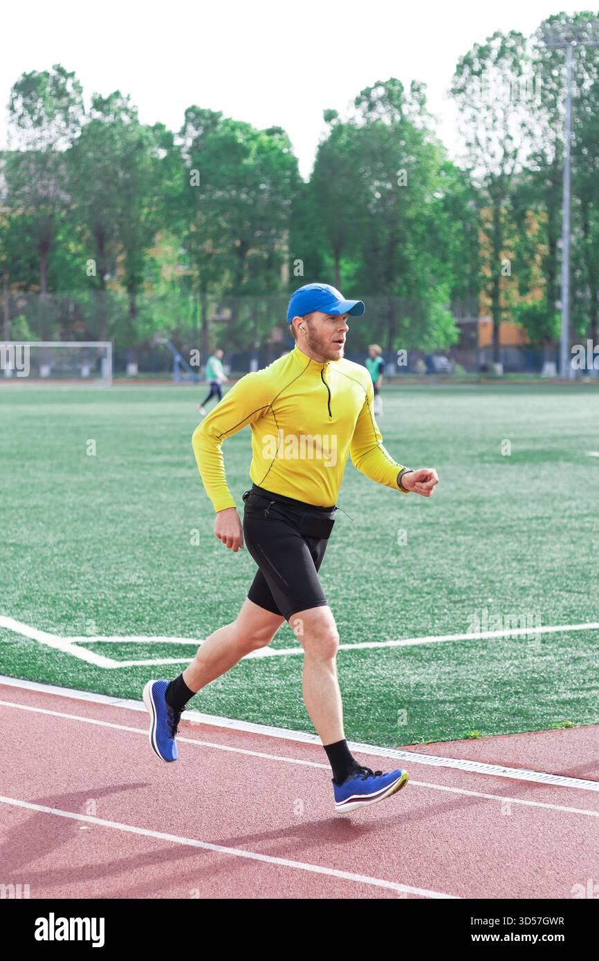Athlete training and running on stadium Stock Photo - Alamy