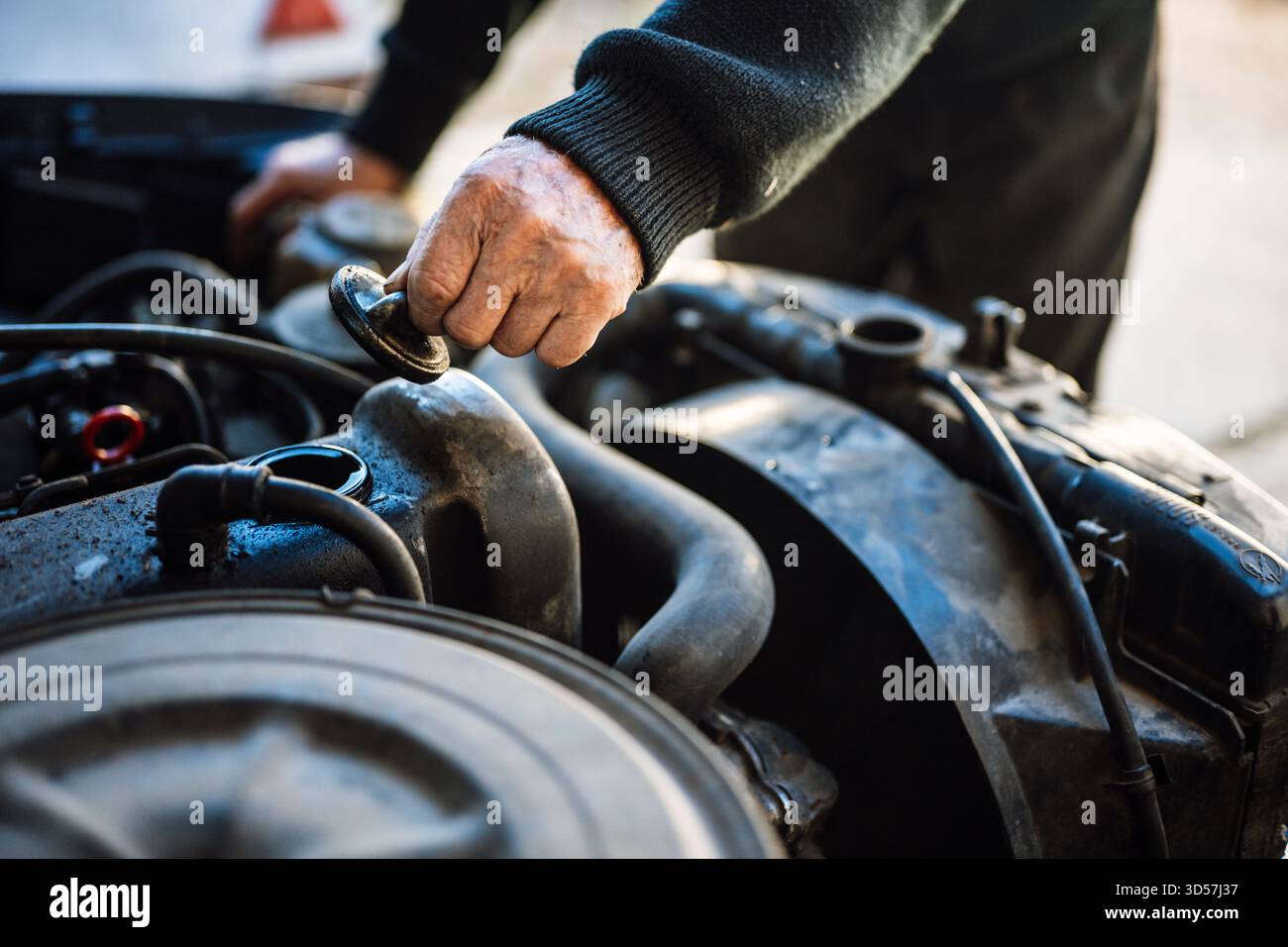 Man inspecting car engine in workshop Stock Photo