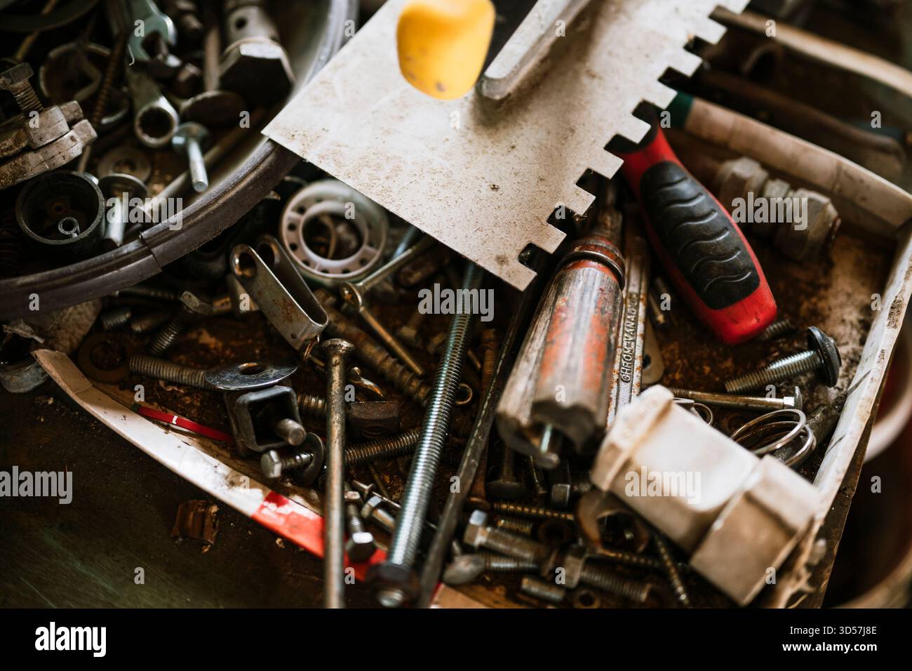 Various tools and hardware scattered in a workshop Stock Photo