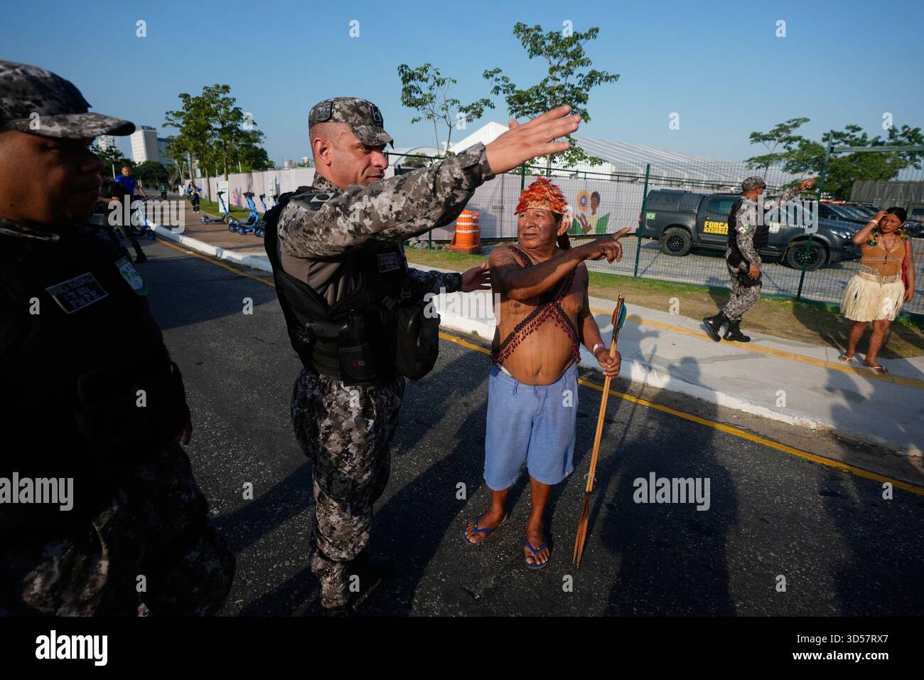 Security personnel ask an Indigenous group for permission to enter a ...