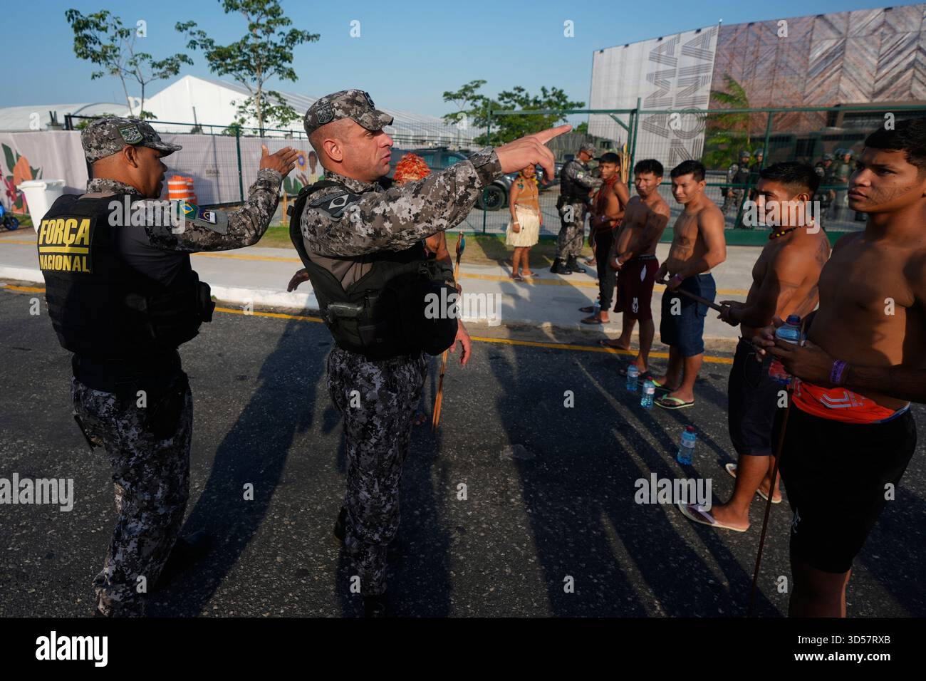 Security personnel ask an Indigenous group for permission to enter a ...