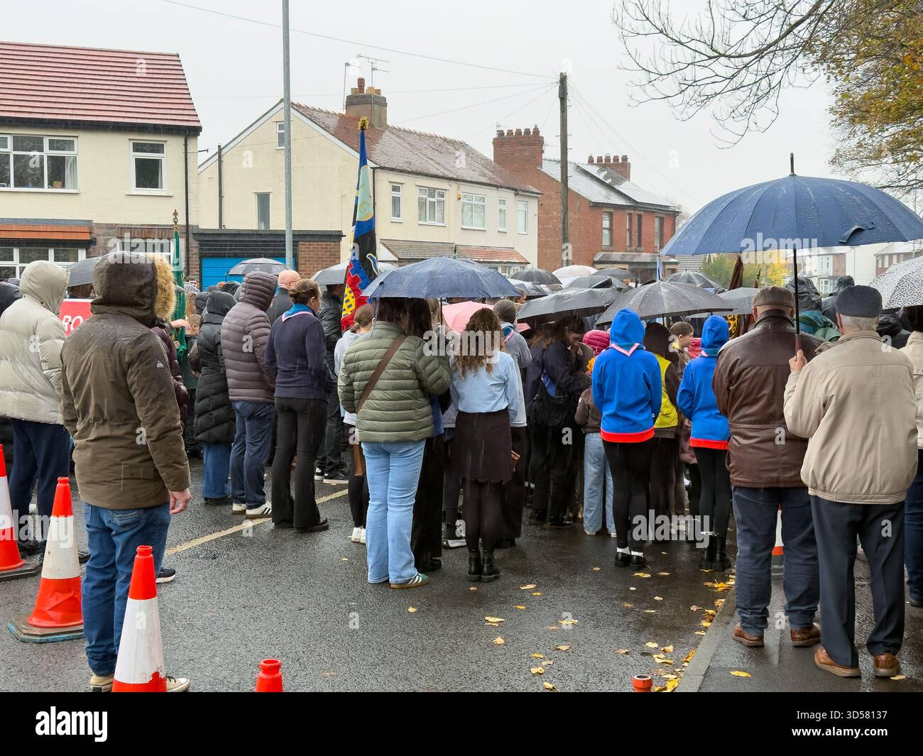 Ormskirk Remembrance Parade, Ormskirk Lancashire UK UK. Despite the pouring rain many people turned out mark the occasion and pay their respects. Nove - Smartphone Captured Stock Image