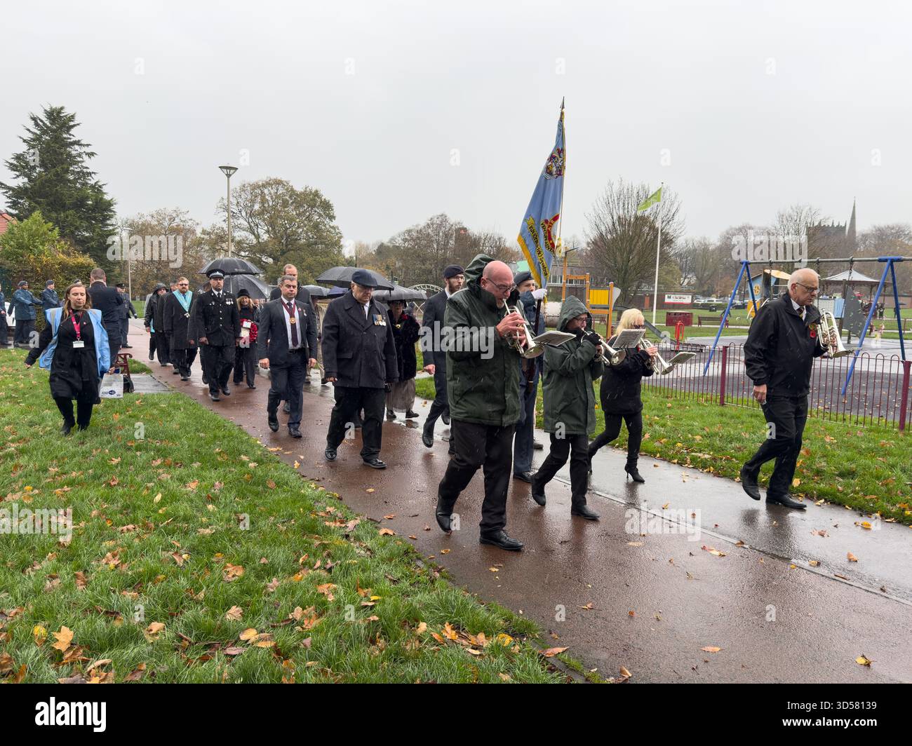 Ormskirk Remembrance Parade, Ormskirk Lancashire UK UK. Despite the pouring rain many people turned out mark the occasion and pay their respects. Nove - Smartphone Captured Stock Image